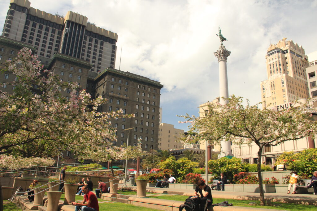 View of Union Square with trees in bloom and people sitting on steps