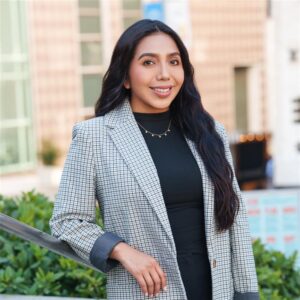 Portrait of Marlenne Mendoza, Project Coordinator, standing outdoors in Union Square with a blurred city backdrop.