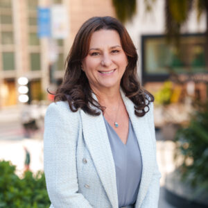 Portrait of Daniela Vasile, Chief Operating Officer, standing outdoors in Union Square with a soft city background.